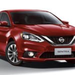 Descrição da imagem #PraCegoVer: Imagem em formato retangular, na horizontal. Nela está o modelo Nissan Sentra,,na cor vermelho malbec, o sedã de luxo da Nissan. Fim da descrição.