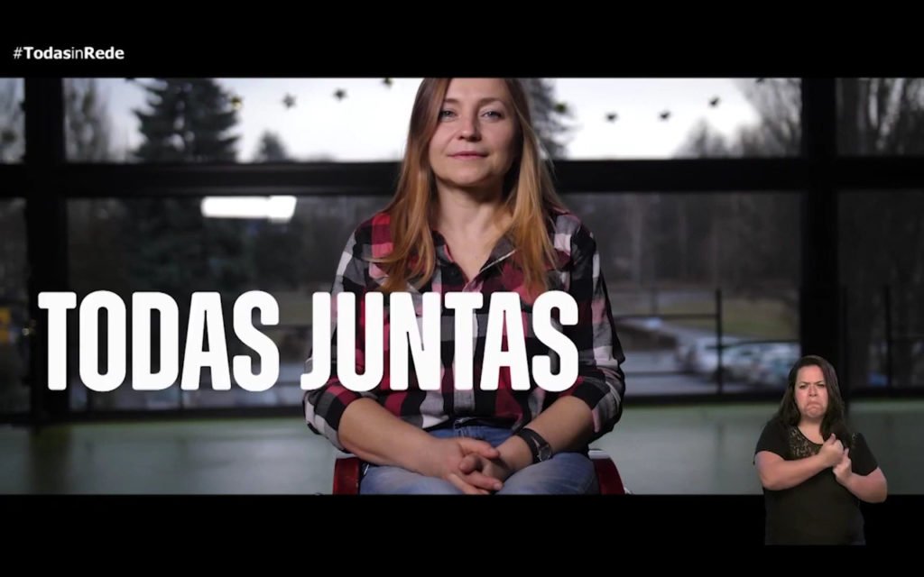 Descrição da imagem #pratodosverem: Reprodução do vídeo de divulgação do programa. Imagem frontal de uma mulher cadeirante. Ela é loira e tem cabelos lisos e compridos. A imagem traz, escrito em letras brancas: TODAS JUNTAS. No canto inferior direito está a intérprete de Libras e no canto superior esquerdo está o logo do programa: TODAS in-Rede. Fim da descrição.