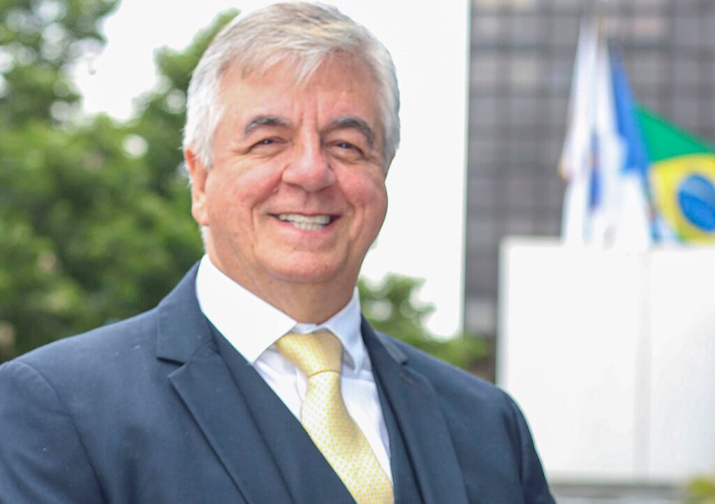 Descrição da imagem #pracegover: Foto de Geraldo Nogueira. Ele é um homem moreno, de cabelos curtos e grisalhos. Geraldo está vestindo terno azul, camisa social branca e gravata amarela. Fim da descrição.