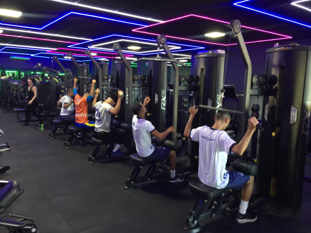 Descrição da imagem: foto dos atletas da seleção de Futebol masculino durante treino na academia. Fim da descrição.