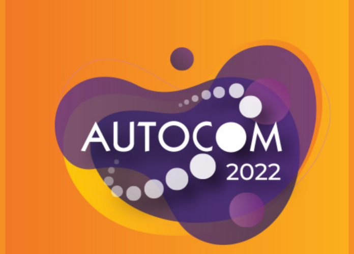 Descrição da imagem: Arte de divulgação do evento Autocom. A arte tem fundo laranja e no centro está o logo da Autocom, dentro de uma forma orgânica cor roxa. Fim da descrição.